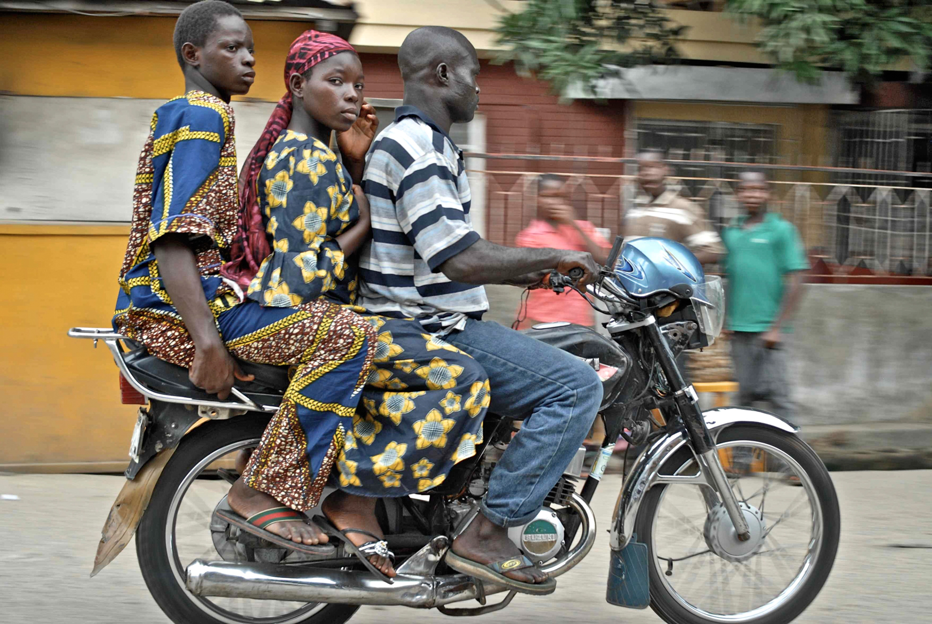 A family commuting together on a motorcycle in Nigeria